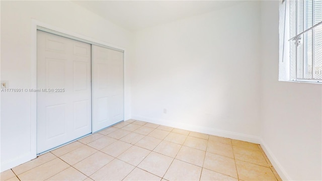 1190 NW 65th St, Miami, FL 33150 - unfurnished bedroom with a closet and light tile patterned flooring