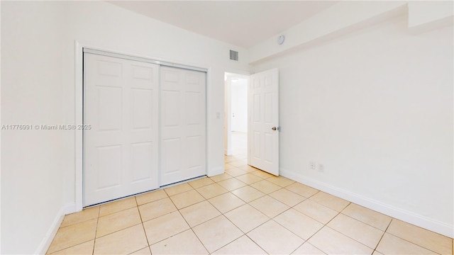1190 NW 65th St, Miami, FL 33150 - unfurnished bedroom with light tile patterned flooring and a closet
