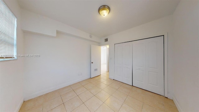 1190 NW 65th St, Miami, FL 33150 - unfurnished bedroom with light tile patterned flooring and a closet