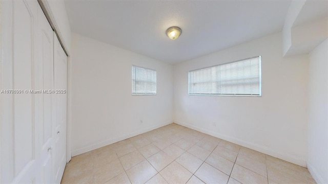 1190 NW 65th St, Miami, FL 33150 - unfurnished bedroom featuring a closet and light tile patterned floors