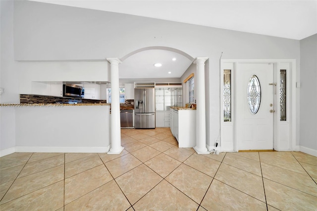 1115 NE 1st Ct Unit A, Hallandale Beach, FL 33009 - entrance foyer featuring arched walkways, light tile patterned floors, decorative columns, and recessed lighting