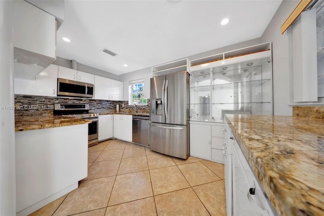 1115 NE 1st Ct Unit A, Hallandale Beach, FL 33009 - kitchen featuring stainless steel appliances, white cabinets, backsplash, light tile patterned flooring, and recessed lighting