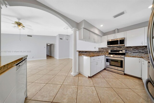 1115 NE 1st Ct Unit A, Hallandale Beach, FL 33009 - kitchen with stainless steel appliances, tasteful backsplash, light tile patterned flooring, white cabinets, and recessed lighting