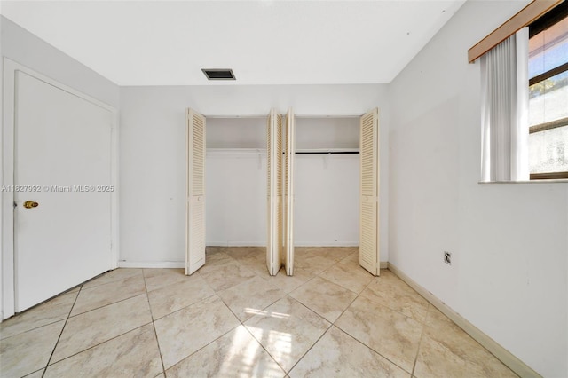 1115 NE 1st Ct Unit A, Hallandale Beach, FL 33009 - unfurnished bedroom featuring two closets and tile patterned flooring