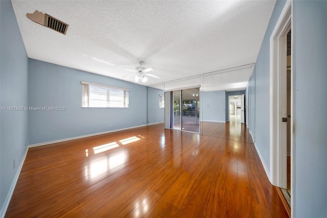 1115 NE 1st Ct Unit A, Hallandale Beach, FL 33009 - empty room featuring a textured ceiling, ceiling fan, and wood finished floors