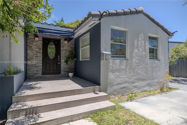 2125 SW 26th St, Miami, FL 33133 - property entrance with stucco siding and a tiled roof