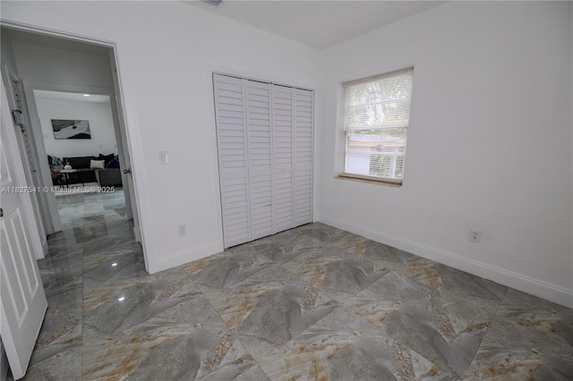 2125 SW 26th St, Miami, FL 33133 - unfurnished bedroom with marble tiled flooring and a closet