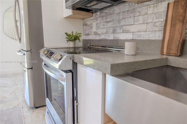2125 SW 26th St, Miami, FL 33133 - kitchen with stainless steel electric range oven, backsplash, and freestanding refrigerator