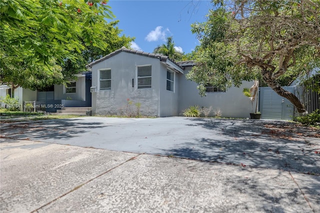 2125 SW 26th St, Miami, FL 33133 - view of side of property with stucco siding and a tile roof