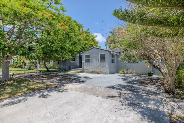 2125 SW 26th St, Miami, FL 33133 - view of front of house featuring concrete driveway and stucco siding