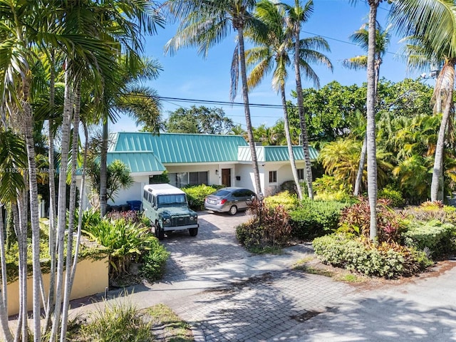 1375 N Biscayne Point Rd, Miami Beach, FL 33141 - view of front of property featuring stucco siding, a metal roof, decorative driveway, and a standing seam roof