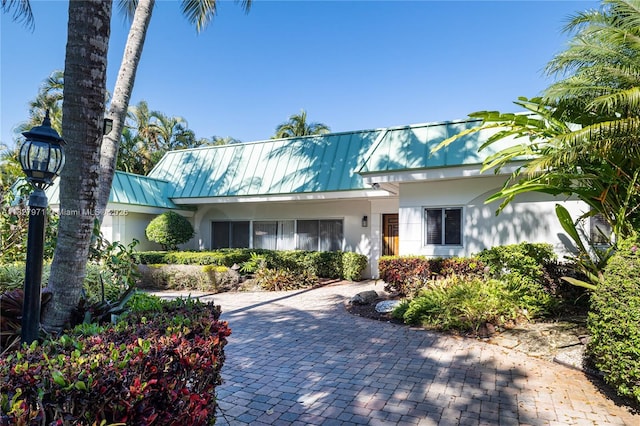 1375 N Biscayne Point Rd, Miami Beach, FL 33141 - view of front of home with stucco siding, a metal roof, and a standing seam roof