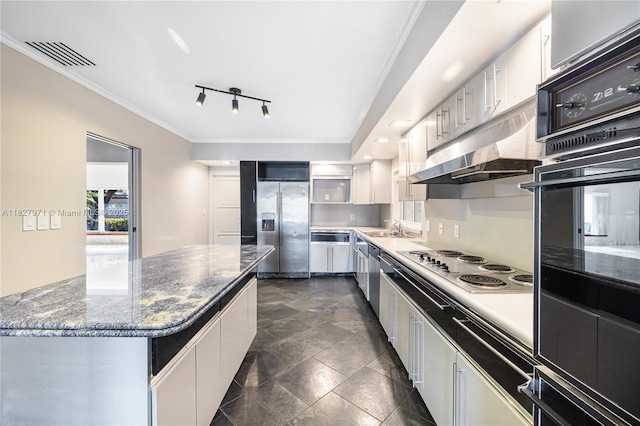 1375 N Biscayne Point Rd, Miami Beach, FL 33141 - kitchen with appliances with stainless steel finishes, ornamental molding, white cabinets, under cabinet range hood, and a center island