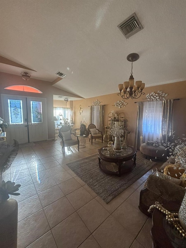 330 N Deerfield Ave, Deerfield Beach, FL 33441 - tiled living area featuring lofted ceiling, a chandelier, a textured ceiling, and french doors