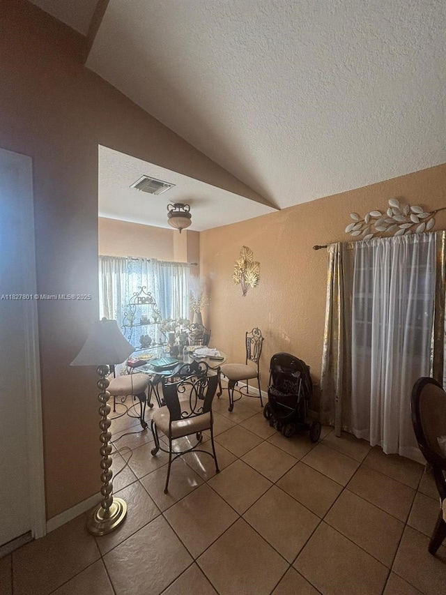 330 N Deerfield Ave, Deerfield Beach, FL 33441 - tiled dining area featuring vaulted ceiling and a textured ceiling