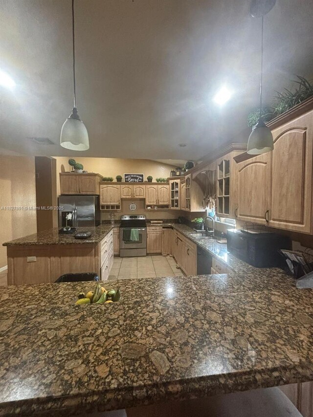 330 N Deerfield Ave, Deerfield Beach, FL 33441 - kitchen with appliances with stainless steel finishes, glass insert cabinets, lofted ceiling, a center island, and dark stone counters