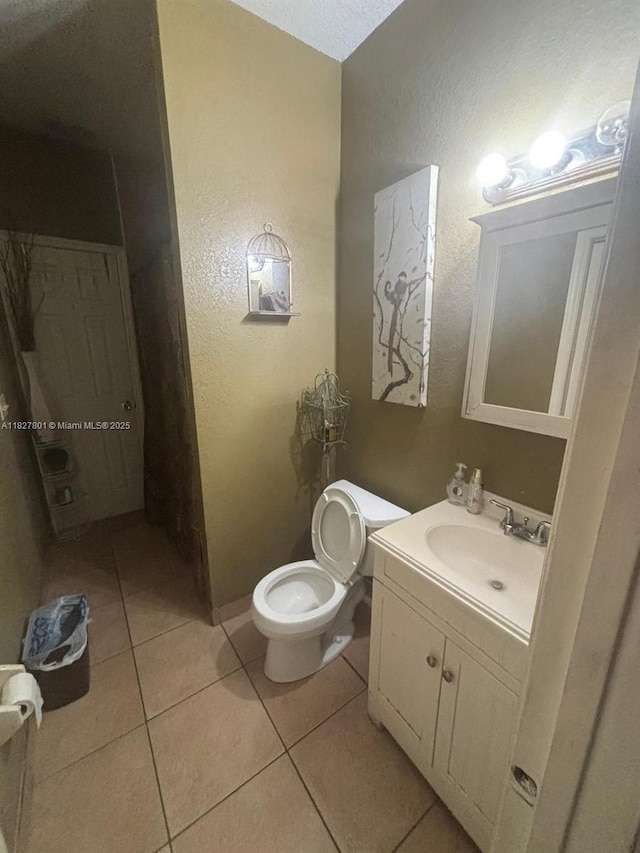 330 N Deerfield Ave, Deerfield Beach, FL 33441 - bathroom featuring vanity, tile patterned floors, and a textured wall