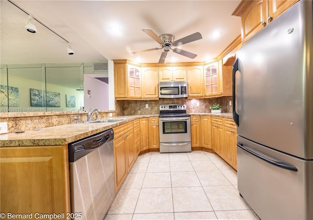 3021 Ventnor H Unit 3021, Deerfield Beach, FL 33442 - kitchen featuring appliances with stainless steel finishes, light tile patterned floors, glass insert cabinets, and decorative backsplash
