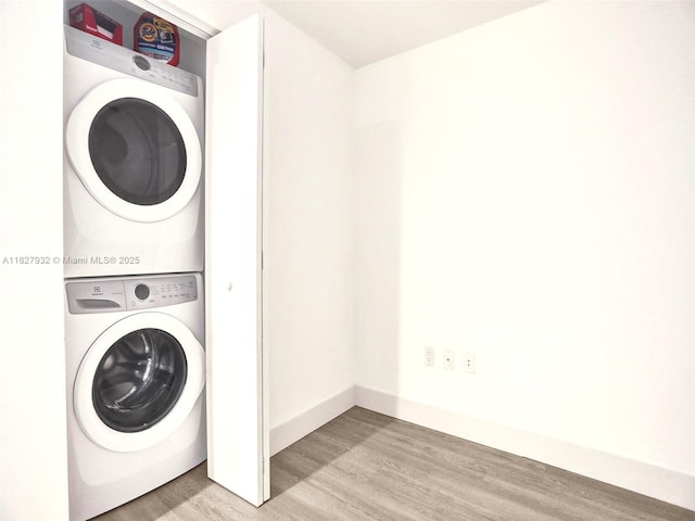 16385 Biscayne Blvd Unit 403, North Miami Beach, FL 33160 - laundry area featuring stacked washer / drying machine and light wood-type flooring