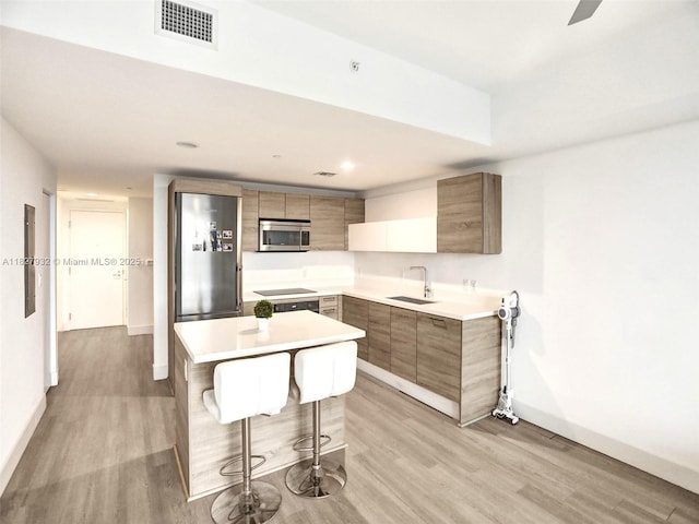 16385 Biscayne Blvd Unit 403, North Miami Beach, FL 33160 - kitchen with appliances with stainless steel finishes, modern cabinets, a breakfast bar, light wood-style floors, and recessed lighting