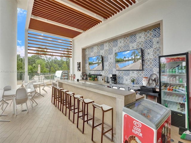 16385 Biscayne Blvd Unit 403, North Miami Beach, FL 33160 - bar area with tasteful backsplash, light wood-style flooring, and floor to ceiling windows