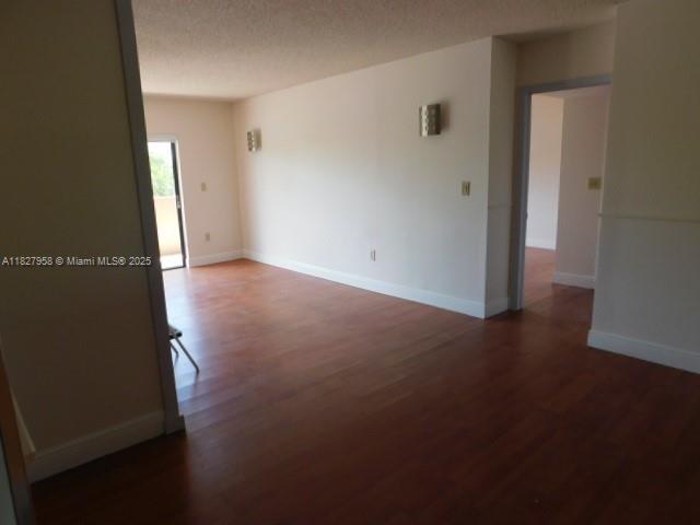 5900 SW 127th Ave Unit 3304, Miami, FL 33183 - empty room with wood finished floors and a textured ceiling