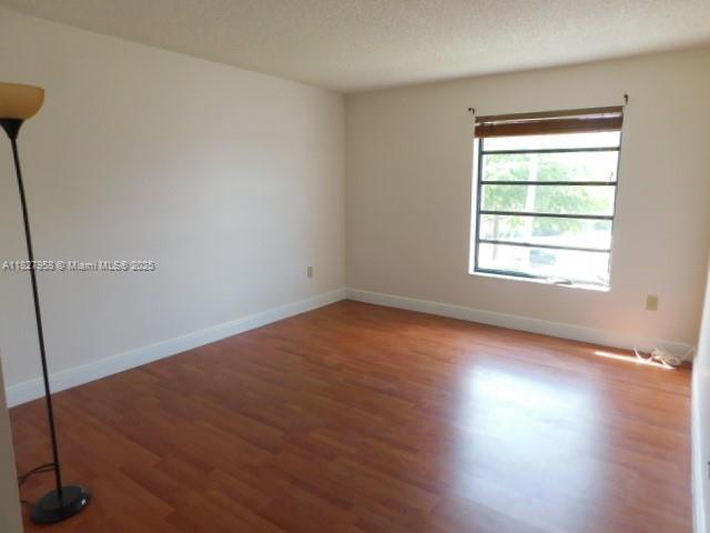 5900 SW 127th Ave Unit 3304, Miami, FL 33183 - unfurnished room with wood finished floors and baseboards
