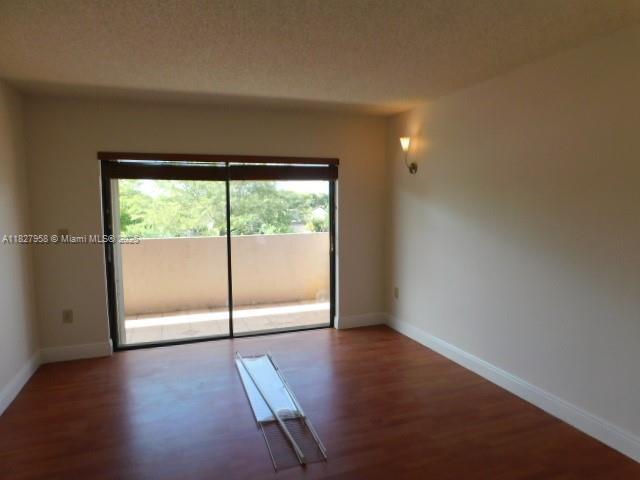 5900 SW 127th Ave Unit 3304, Miami, FL 33183 - empty room with wood finished floors and baseboards