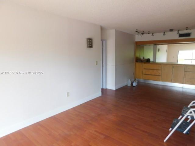 5900 SW 127th Ave Unit 3304, Miami, FL 33183 - unfurnished living room featuring wood finished floors and track lighting