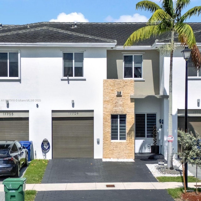 17709 SW 150th Ct, Miami, FL 33187 - view of front of home featuring stucco siding, an attached garage, and driveway