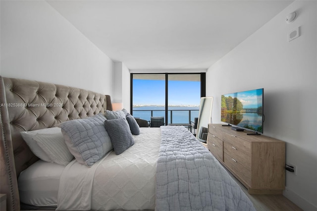 460 NE 28th St Unit 2407, Miami, FL 33137 - bedroom with a wall of windows, wood finished floors, and access to exterior