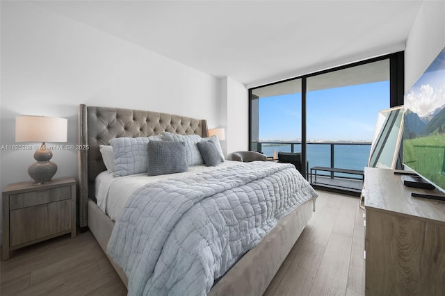 460 NE 28th St Unit 2407, Miami, FL 33137 - bedroom featuring floor to ceiling windows, light wood-type flooring, and access to exterior