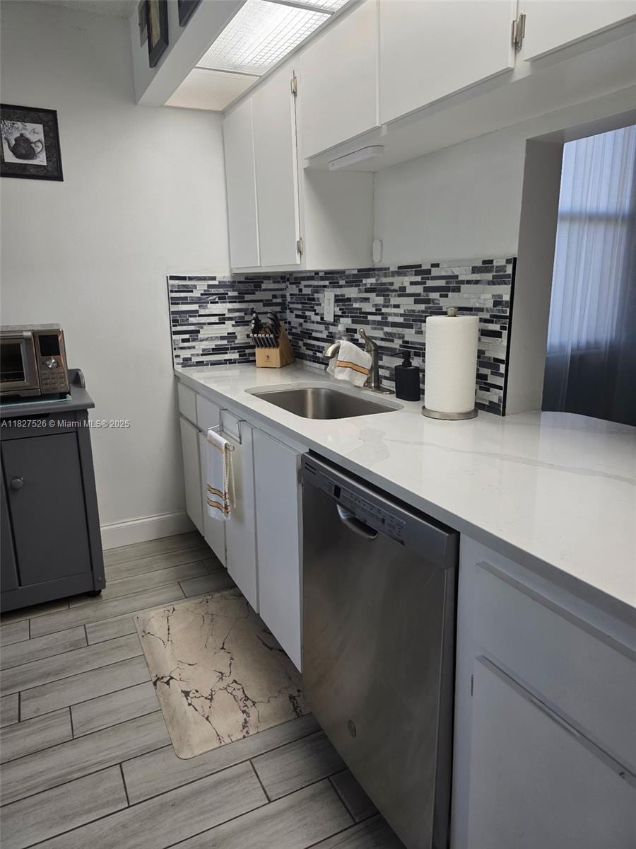 6800 Cypress Rd Unit 106, Plantation, FL 33317 - kitchen with dishwasher, white cabinets, tasteful backsplash, and light wood-style floors