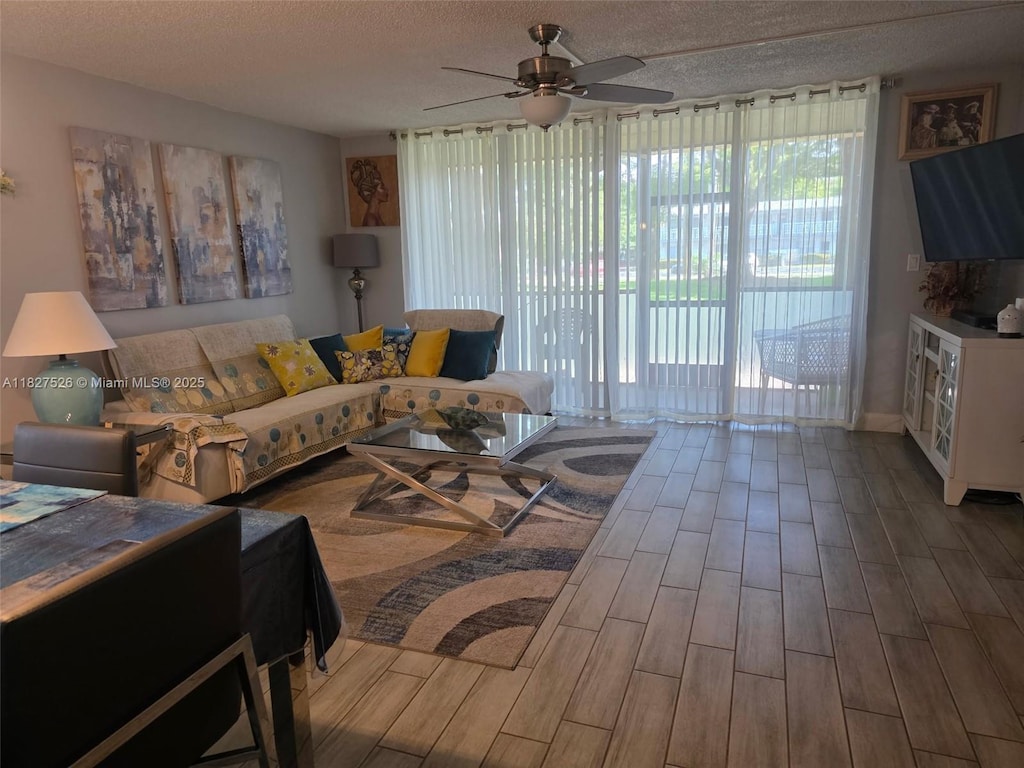 6800 Cypress Rd Unit 106, Plantation, FL 33317 - living room featuring ceiling fan, wood finished floors, and a textured ceiling