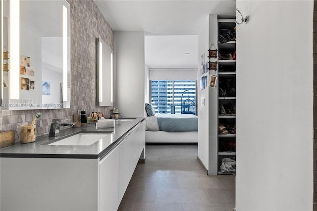 88 SW 7th St Unit 1008, Miami, FL 33130 - ensuite bathroom with double vanity and decorative backsplash
