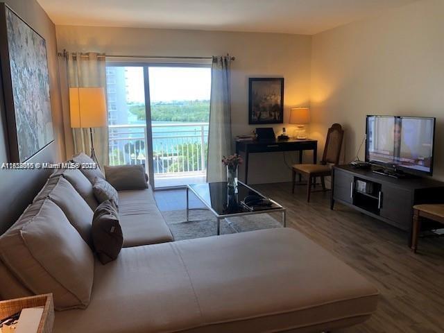 400 Kings Point Dr Unit 820, Sunny Isles Beach, FL 33160 - living area featuring healthy amount of natural light and wood finished floors