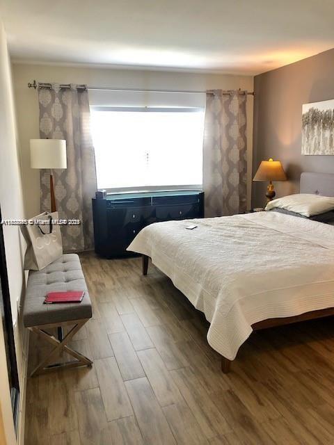 400 Kings Point Dr Unit 820, Sunny Isles Beach, FL 33160 - bedroom with wood finished floors