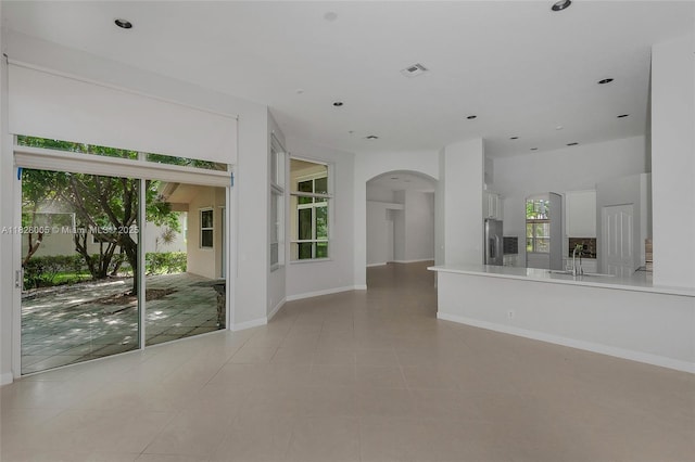 3843 Oak Ridge Cir, Weston, FL 33331 - unfurnished living room featuring arched walkways, recessed lighting, and light tile patterned floors