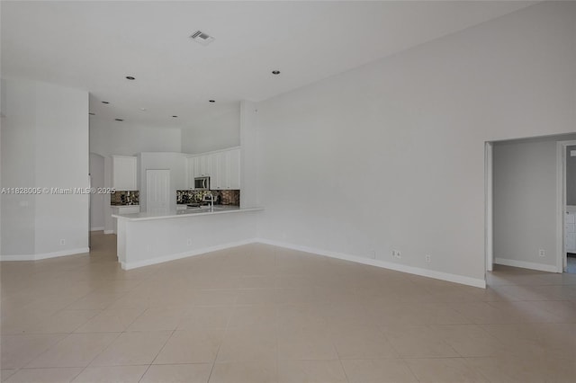 3843 Oak Ridge Cir, Weston, FL 33331 - unfurnished living room featuring a high ceiling and light tile patterned flooring