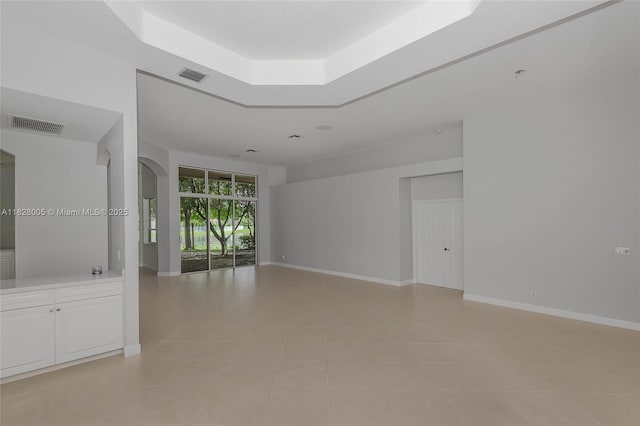 3843 Oak Ridge Cir, Weston, FL 33331 - unfurnished room with light tile patterned floors, a raised ceiling, and arched walkways