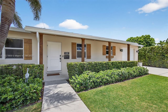 228 Rutland Blvd, West Palm Beach, FL 33405 - view of front of property with stucco siding and a front yard