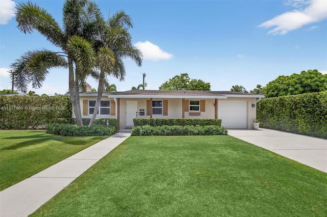228 Rutland Blvd, West Palm Beach, FL 33405 - ranch-style home with an attached garage, stucco siding, a front yard, and driveway