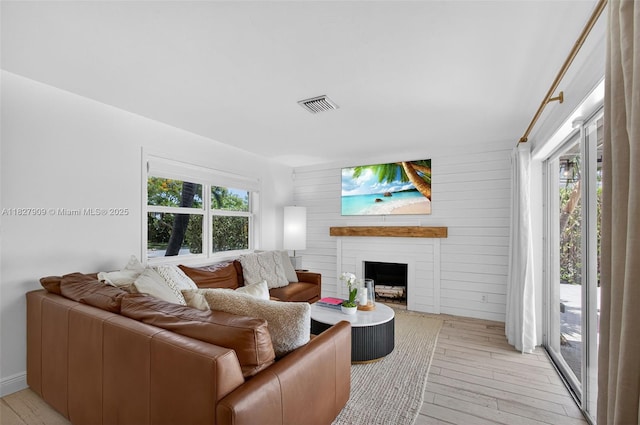 228 Rutland Blvd, West Palm Beach, FL 33405 - living room with light wood-style floors and a fireplace