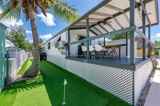 456 Bowie Ln, Key Largo, FL 33037 - view of home's exterior featuring a putting area, ceiling fan, and cooling unit