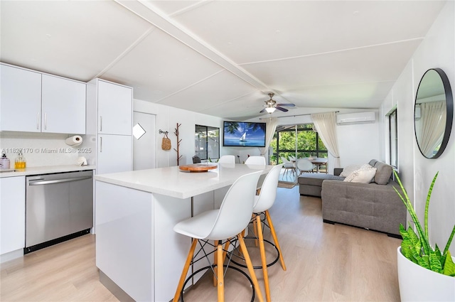 456 Bowie Ln, Key Largo, FL 33037 - kitchen with dishwasher, a wall unit AC, a breakfast bar area, light wood-type flooring, and a ceiling fan