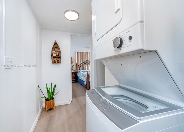 456 Bowie Ln, Key Largo, FL 33037 - laundry room with stacked washer and clothes dryer and light wood-type flooring
