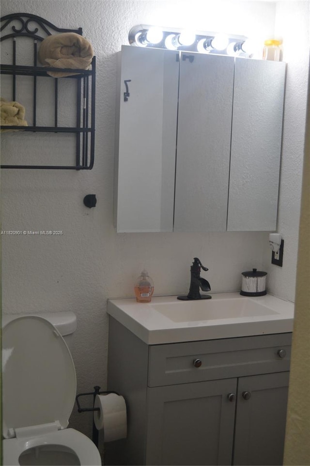 56 Norwich C Unit 56, West Palm Beach, FL 33417 - half bath with vanity and a textured wall