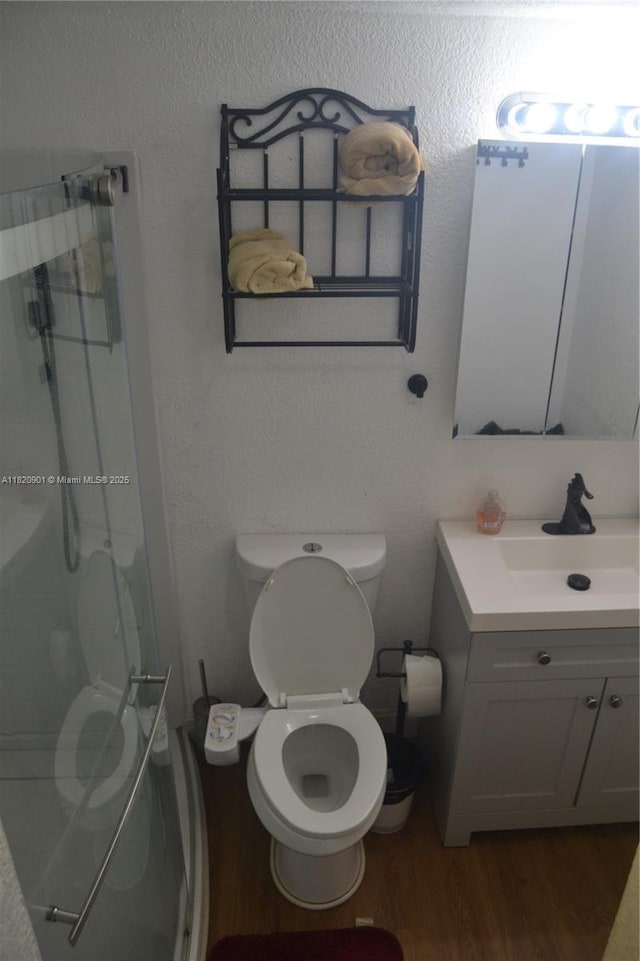 56 Norwich C Unit 56, West Palm Beach, FL 33417 - full bathroom with vanity, a stall shower, and wood finished floors