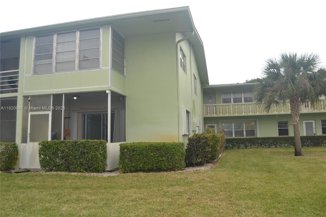 56 Norwich C Unit 56, West Palm Beach, FL 33417 - view of property exterior with a yard and stucco siding