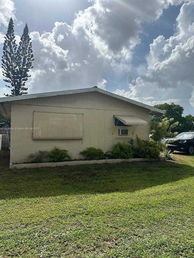 506 York Rd, Lehigh Acres, FL 33936 - view of side of property with concrete block siding and a yard